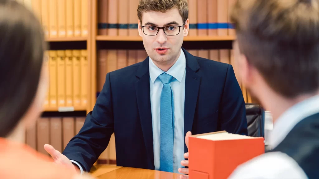 a personal injury lawyer talking to a couple
